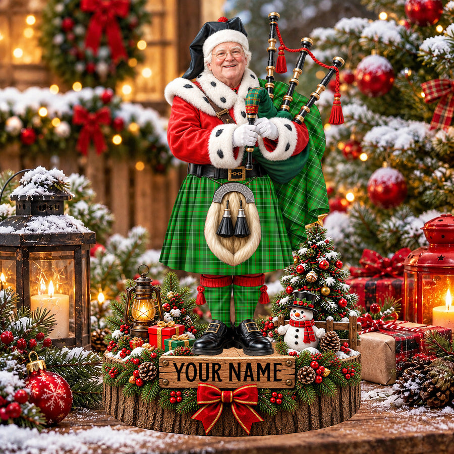 Personalized Christmas piper plaque in the Galloway District tartan, standing on a snowy log base with a name plaque
