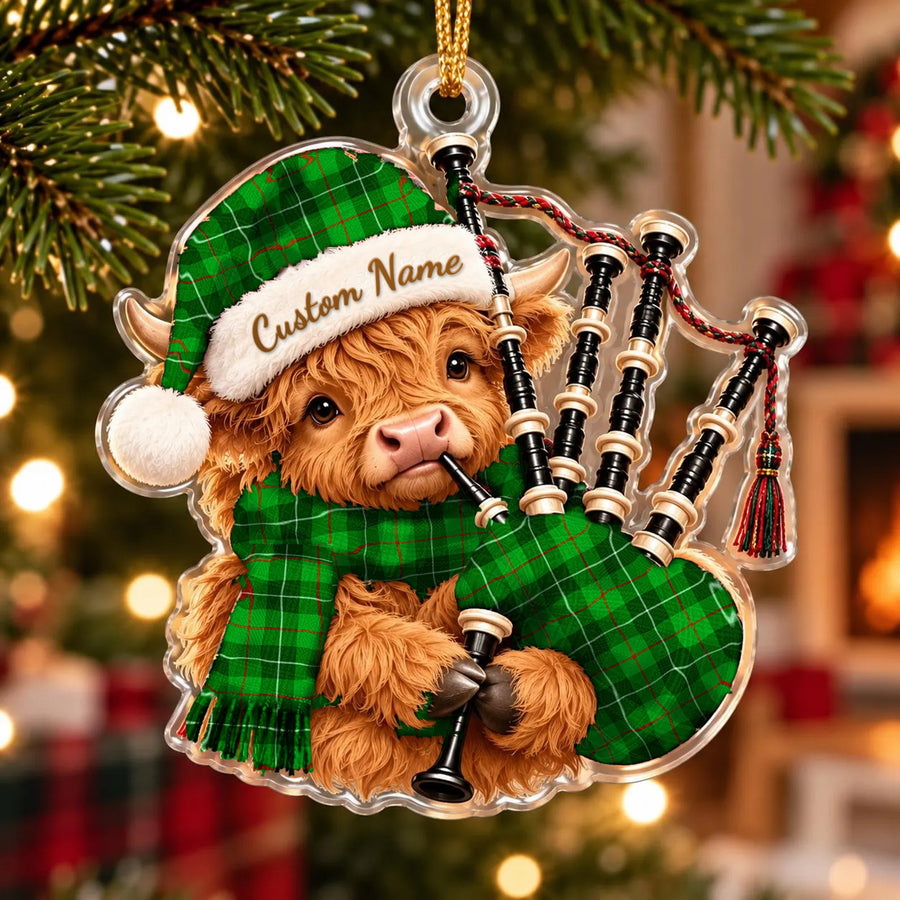 Acrylic Highland cow calf ornament playing the bagpipes, in a Galloway District tartan Santa hat, scarf and pipe bag, with a custom name on the hat