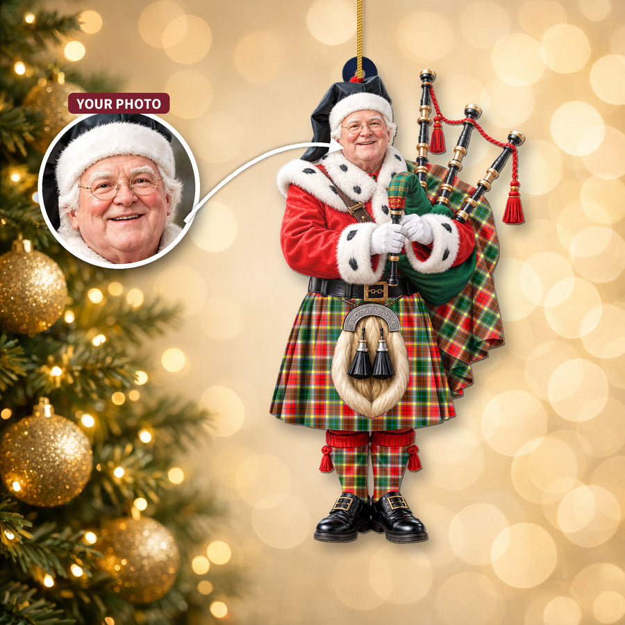 Christmas piper ornament in the Gibbs tartan hanging on a Christmas tree, with the customer photo used for the face