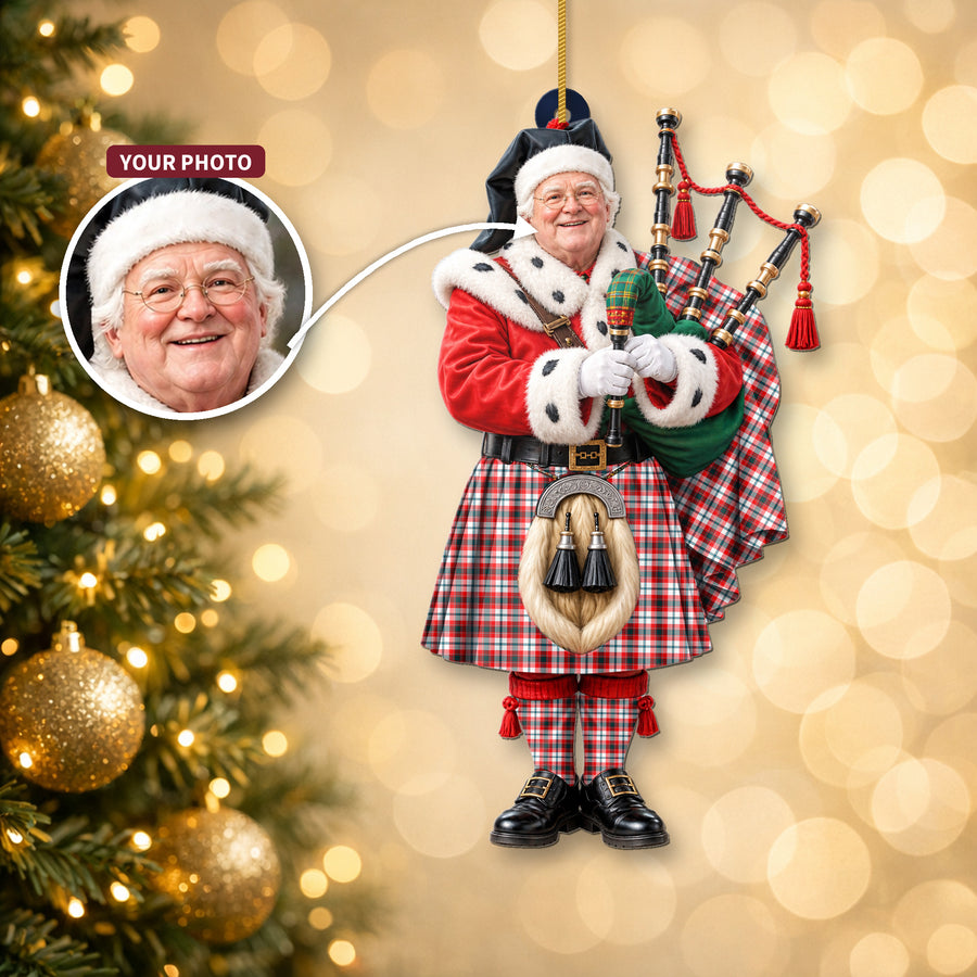 Christmas piper ornament in the Glasgow District tartan hanging on a Christmas tree, with the customer photo used for the face