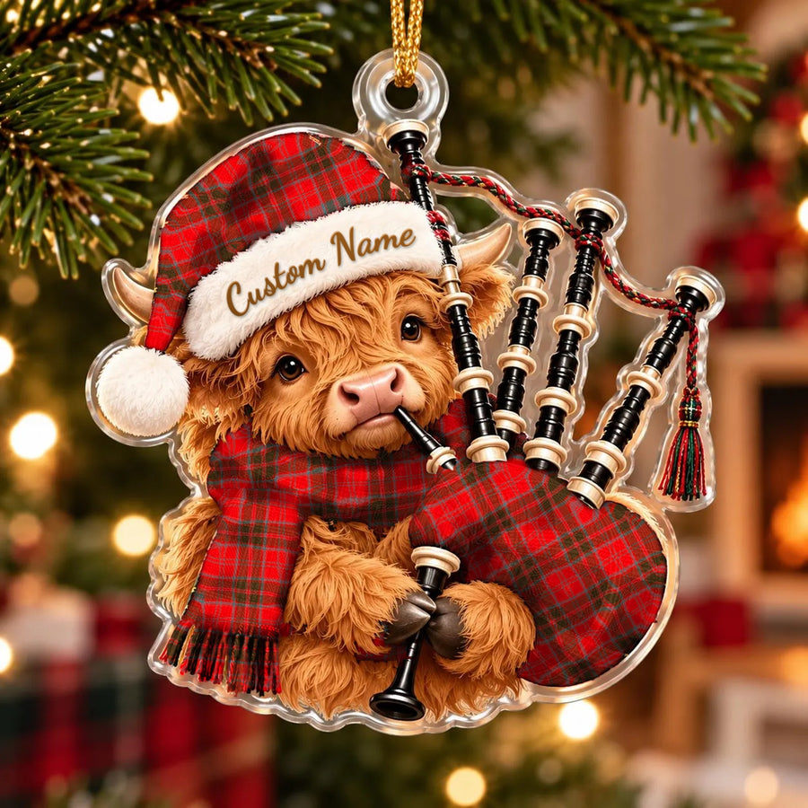 Acrylic Highland cow calf ornament playing the bagpipes, in a Grant Weathered tartan Santa hat, scarf and pipe bag, with a custom name on the hat