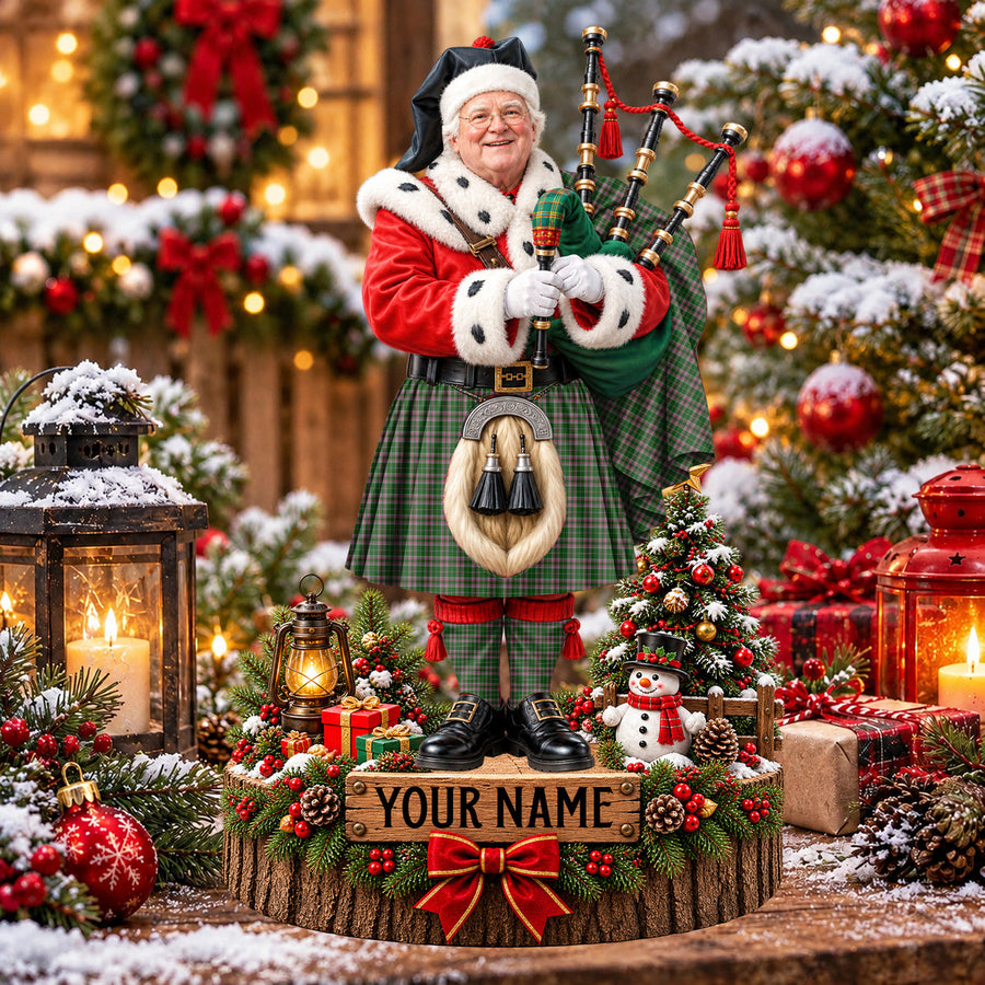 Personalized Christmas piper plaque in the Gray Hunting tartan, standing on a snowy log base with a name plaque