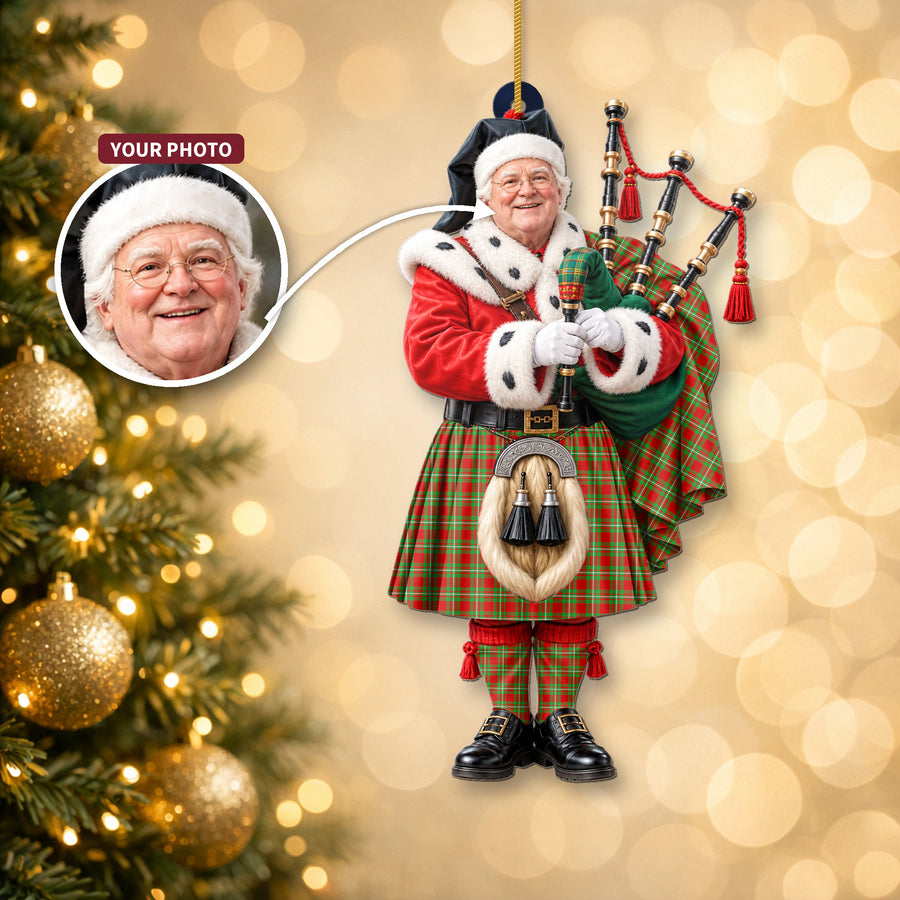 Christmas piper ornament in the Grierson tartan hanging on a Christmas tree, with the customer photo used for the face