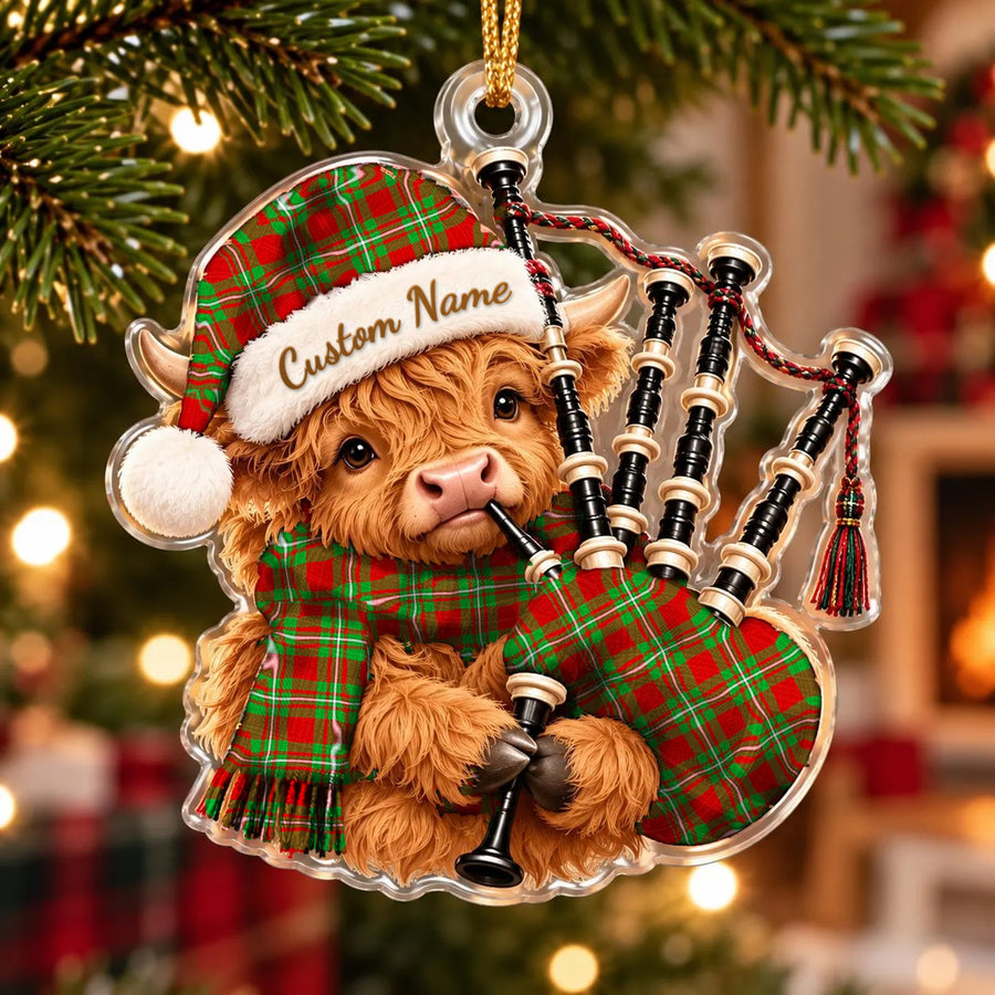 Acrylic Highland cow calf ornament playing the bagpipes, in a Grierson tartan Santa hat, scarf and pipe bag, with a custom name on the hat