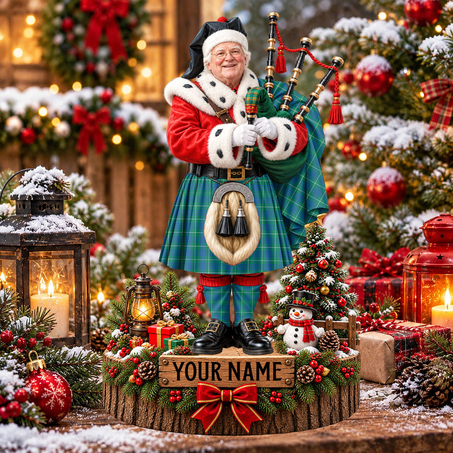 Personalized Christmas piper plaque in the Hamilton Hunting Ancient tartan, standing on a snowy log base with a name plaque