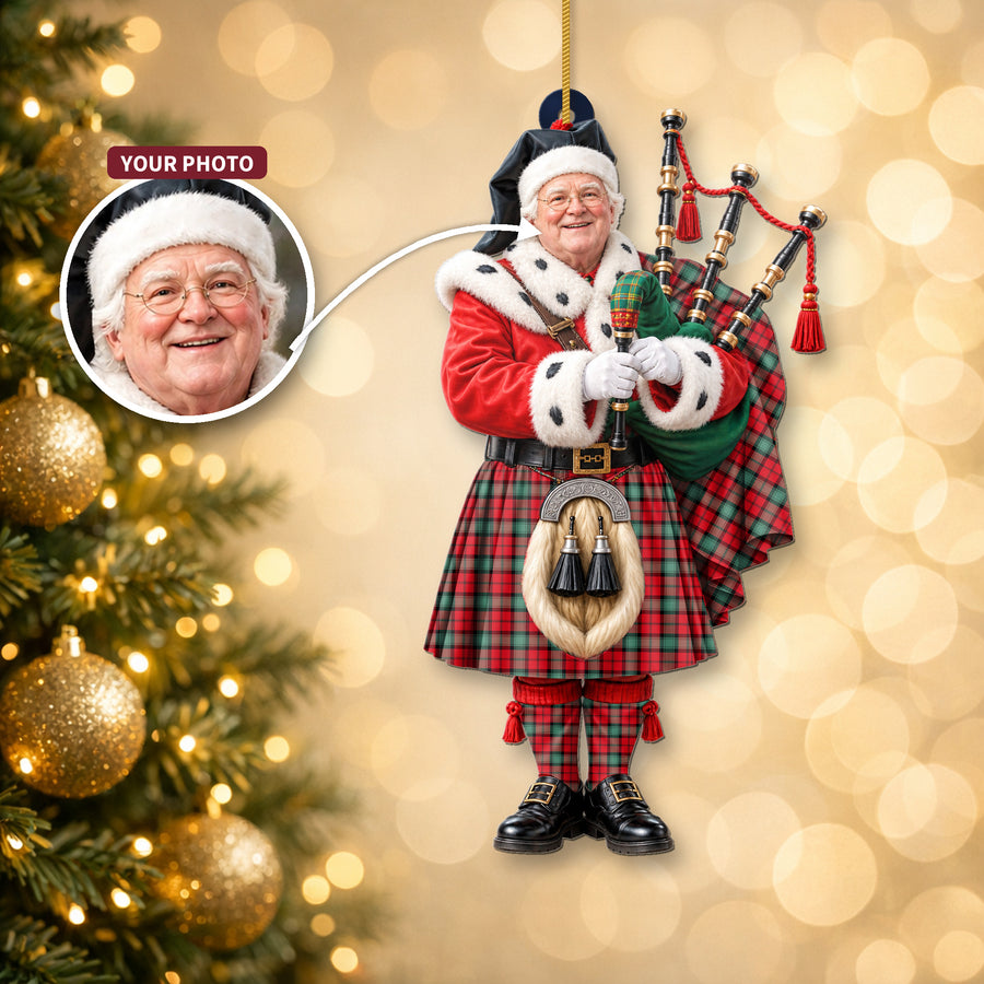 Christmas piper ornament in the Kerr Ancient tartan hanging on a Christmas tree, with the customer photo used for the face