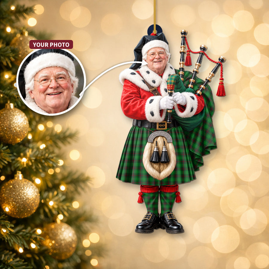 Christmas piper ornament in the Kinloch tartan hanging on a Christmas tree, with the customer photo used for the face