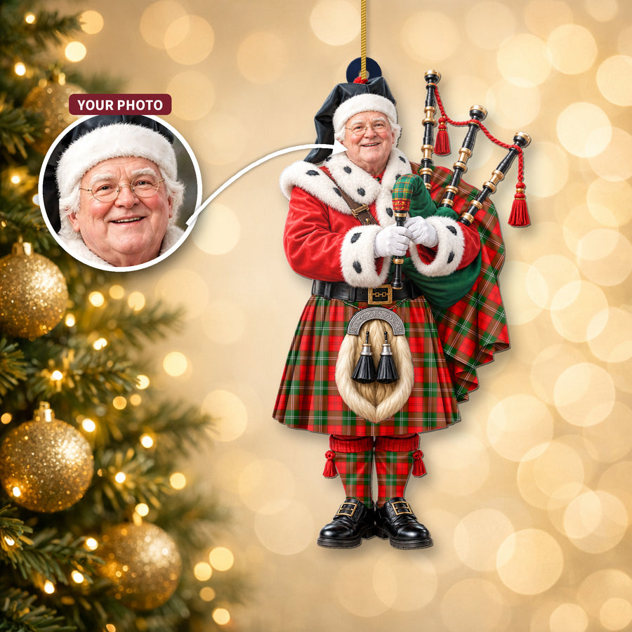 Christmas piper ornament in the Lennox Modern tartan hanging on a Christmas tree, with the customer photo used for the face