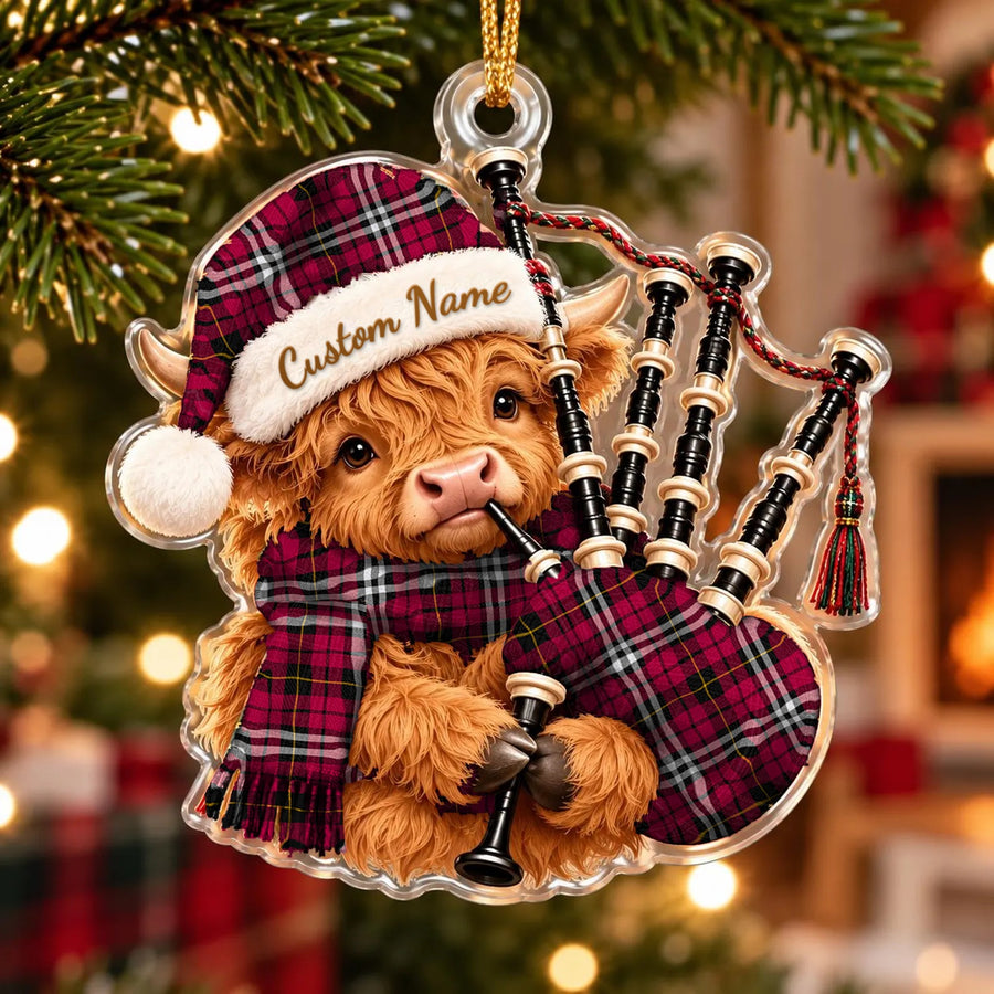 Acrylic Highland cow calf ornament playing the bagpipes, in a Little tartan Santa hat, scarf and pipe bag, with a custom name on the hat