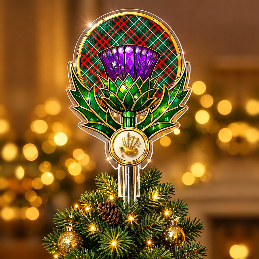Stained-glass style thistle Christmas tree topper with a gold bagpipe emblem and the MacDiarmid Modern tartan behind the thistle
