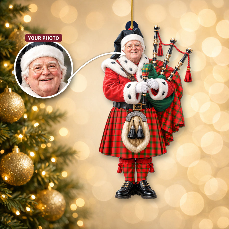 Christmas piper ornament in the MacDonald of Sleat tartan hanging on a Christmas tree, with the customer photo used for the face