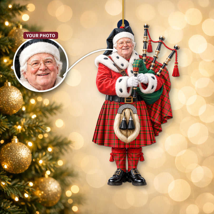 Christmas piper ornament in the MacDonnell of Keppoch Modern tartan hanging on a Christmas tree, with the customer photo used for the face