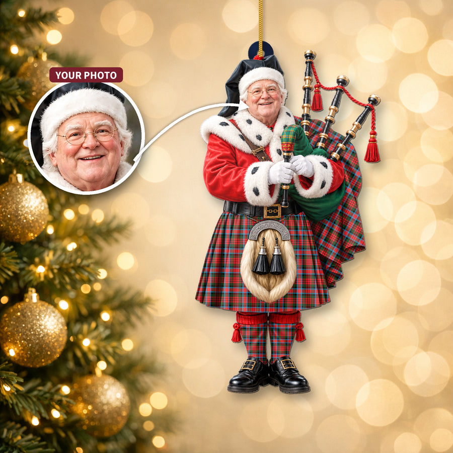 Christmas piper ornament in the MacDuff Modern tartan hanging on a Christmas tree, with the customer photo used for the face