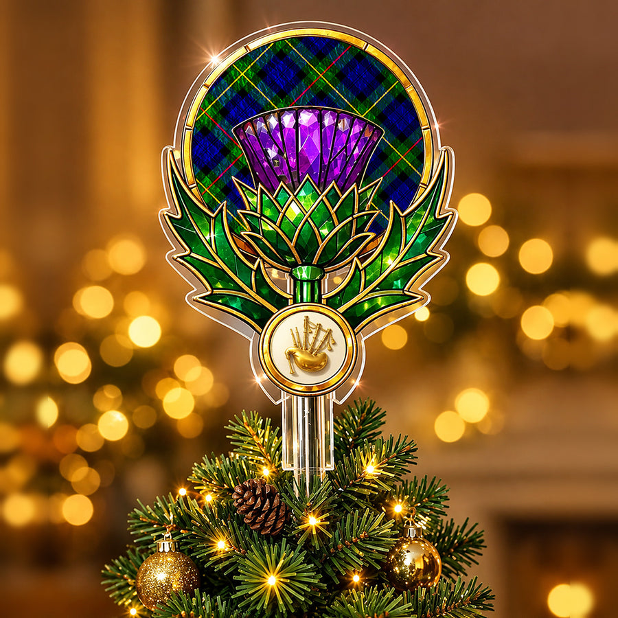 Stained-glass style thistle Christmas tree topper with a gold bagpipe emblem and the MacEwen Modern tartan behind the thistle