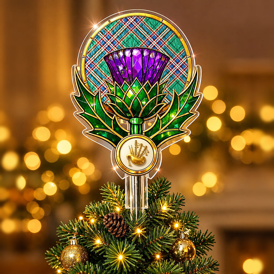 Stained-glass style thistle Christmas tree topper with a gold bagpipe emblem and the MacFarlane Hunting Ancient tartan behind the thistle