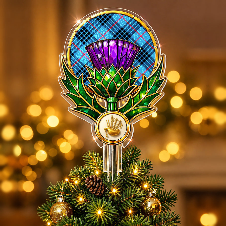 Stained-glass style thistle Christmas tree topper with a gold bagpipe emblem and the MacKay Blue tartan behind the thistle