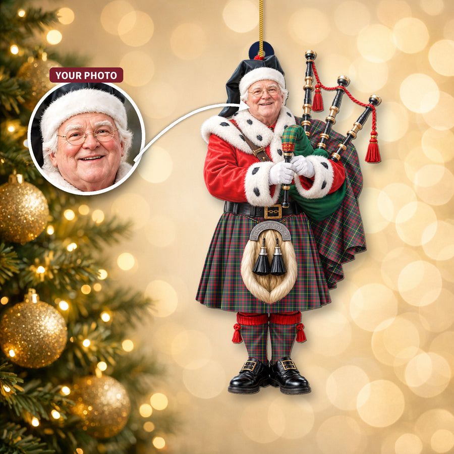 Christmas piper ornament in the MacKintosh Hunting Modern tartan hanging on a Christmas tree, with the customer photo used for the face