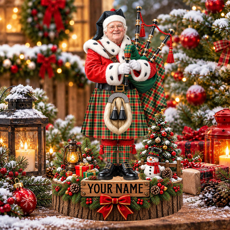 Personalized Christmas piper plaque in the MacLachlan Hunting Modern tartan, standing on a snowy log base with a name plaque
