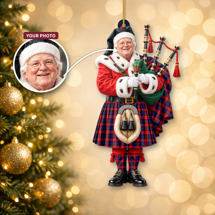 Christmas piper ornament in the MacLachlan Modern tartan hanging on a Christmas tree, with the customer photo used for the face