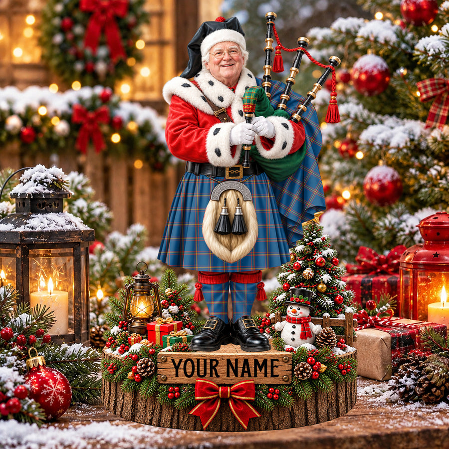 Personalized Christmas piper plaque in the MacLaine of Loch Buie Hunting Ancient tartan, standing on a snowy log base with a name plaque