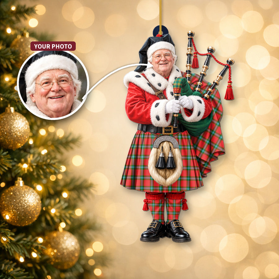 Christmas piper ornament in the MacLaine of Loch Buie tartan hanging on a Christmas tree, with the customer photo used for the face