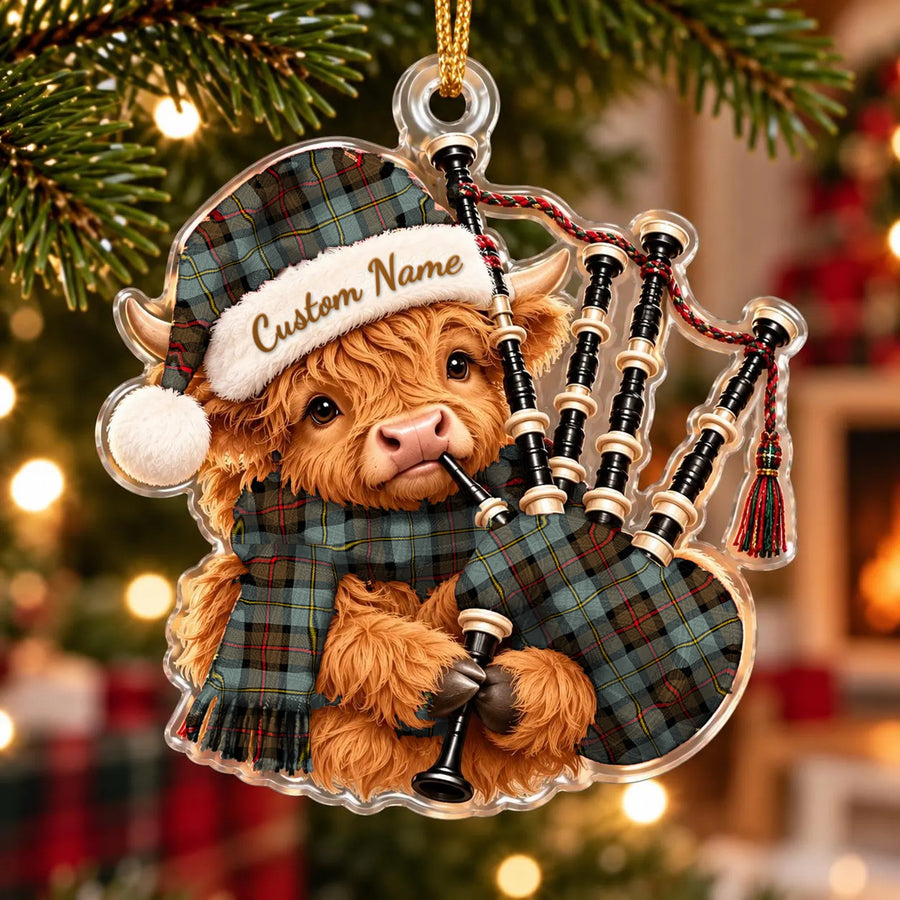 Acrylic Highland cow calf ornament playing the bagpipes, in a MacLeod of Harris Weathered tartan Santa hat, scarf and pipe bag, with a custom name on the hat