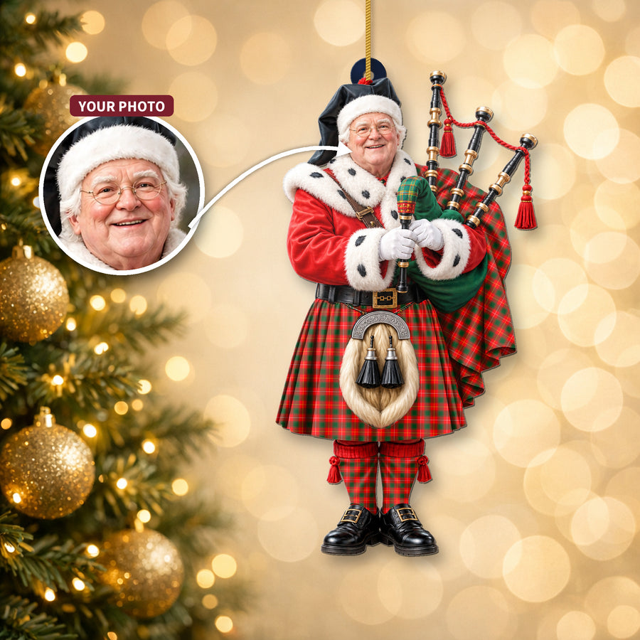 Christmas piper ornament in the MacPhee Modern tartan hanging on a Christmas tree, with the customer photo used for the face