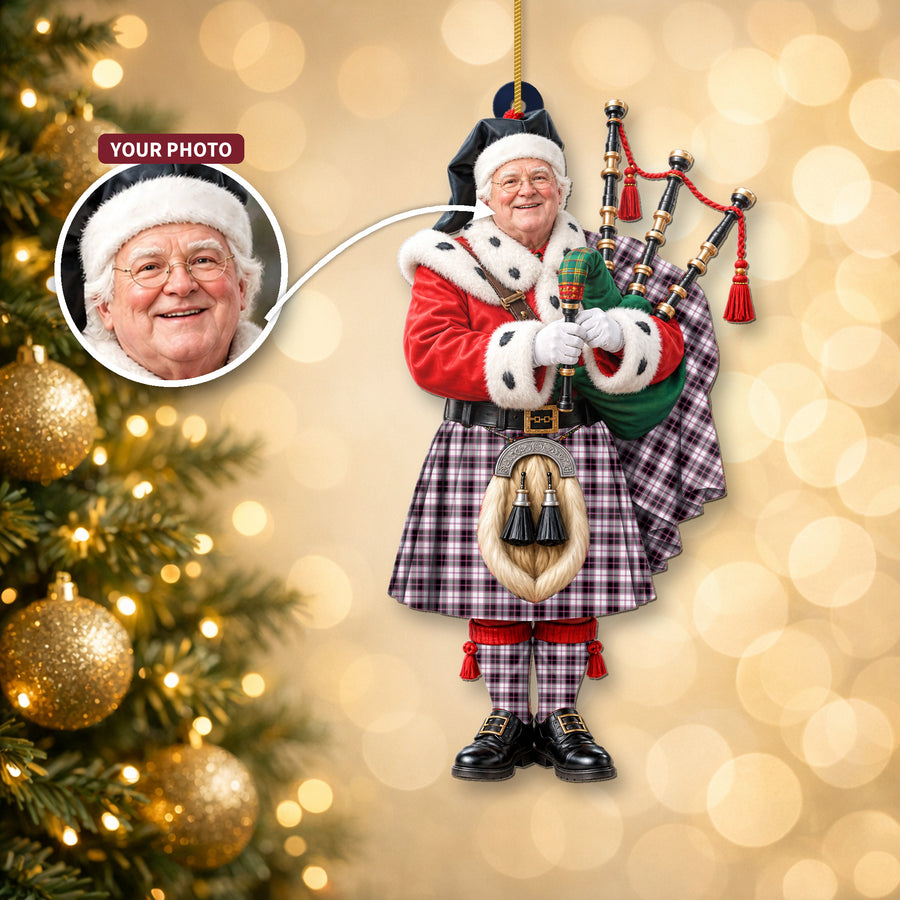 Christmas piper ornament in the MacPherson Hunting Modern tartan hanging on a Christmas tree, with the customer photo used for the face