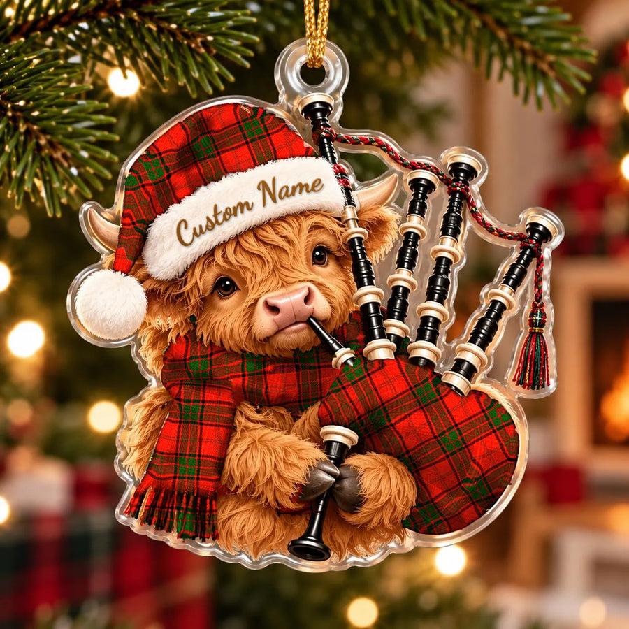Acrylic Highland cow calf ornament playing the bagpipes, in a Maxtone tartan Santa hat, scarf and pipe bag, with a custom name on the hat