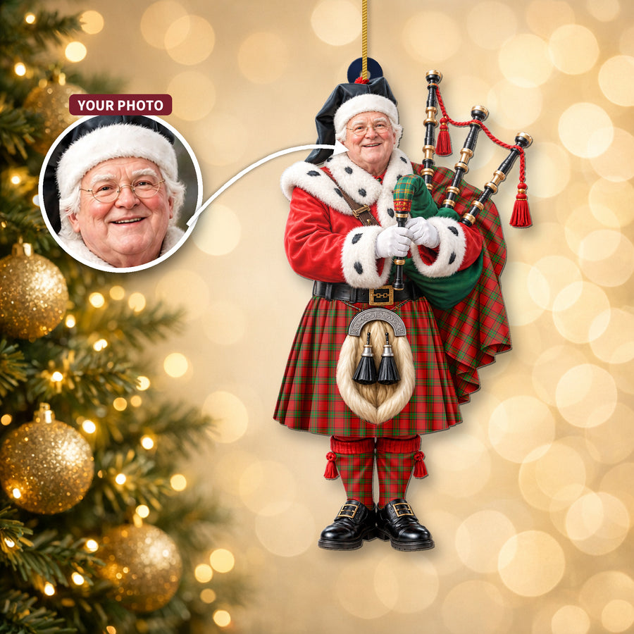 Christmas piper ornament in the Maxwell tartan hanging on a Christmas tree, with the customer photo used for the face