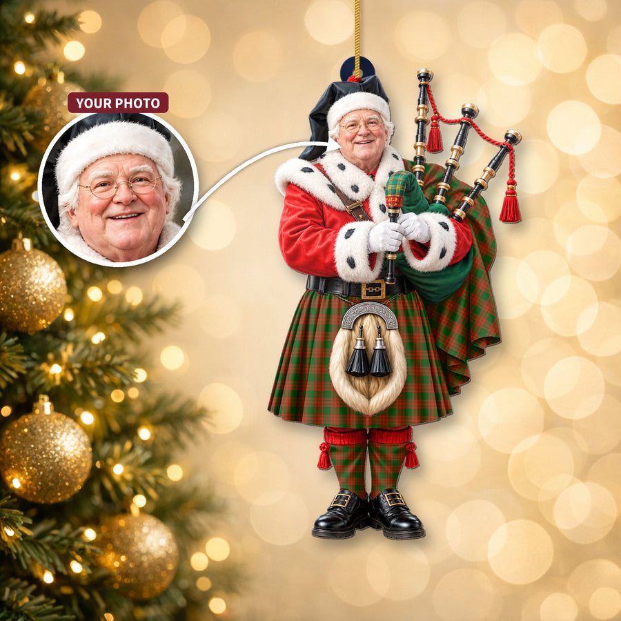 Christmas piper ornament in the Menzies Green Modern tartan hanging on a Christmas tree, with the customer photo used for the face