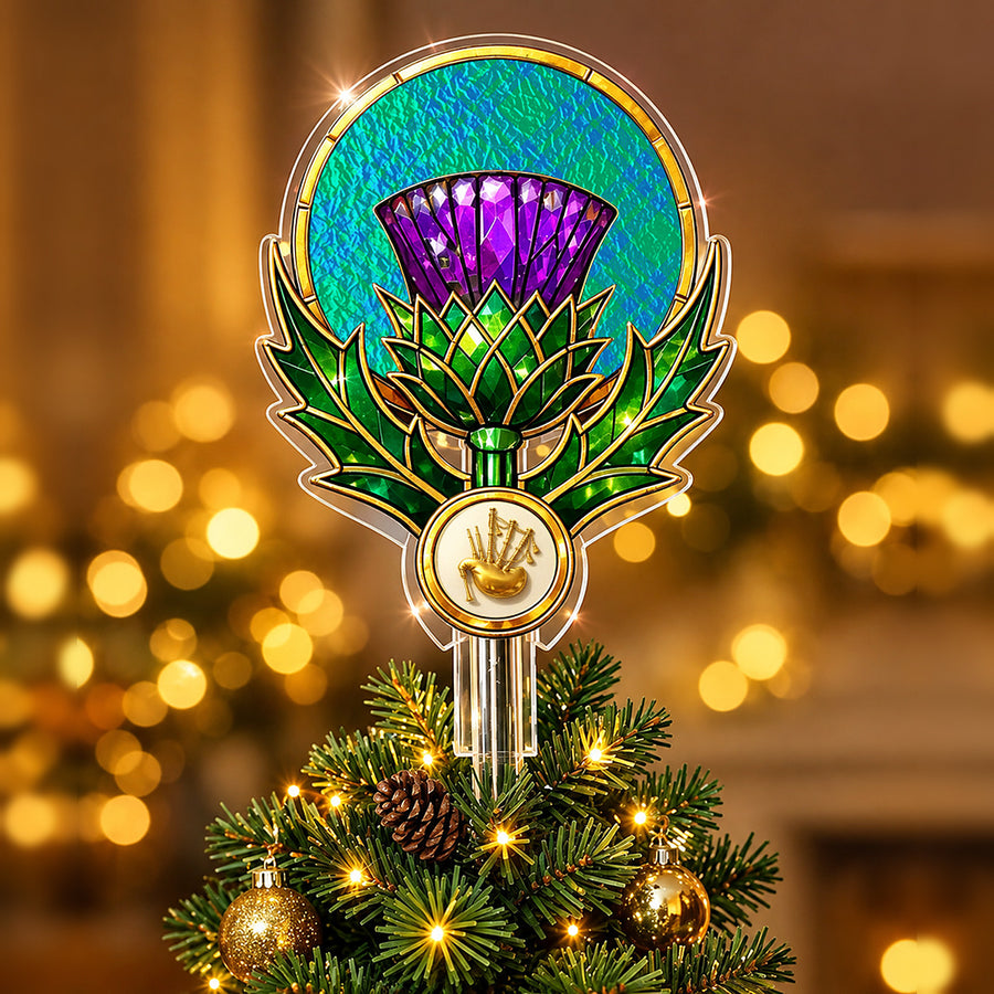 Stained-glass style thistle Christmas tree topper with a gold bagpipe emblem and the Montgomery Ancient tartan behind the thistle