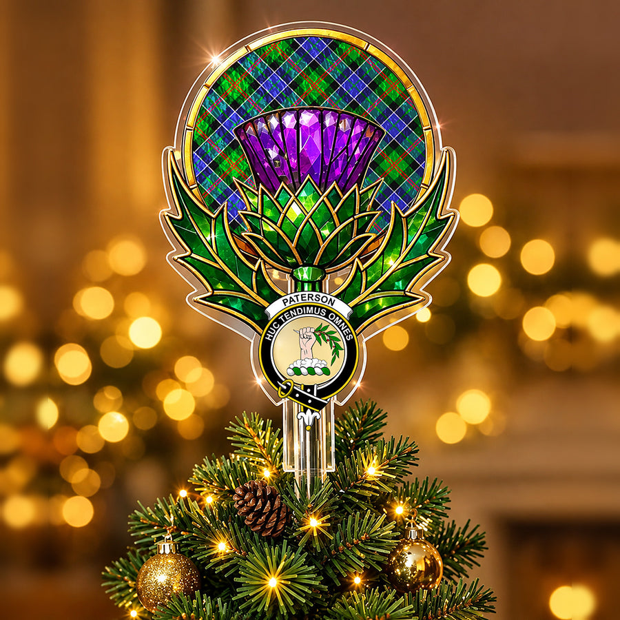 Clan Paterson crest in the centre of a stained-glass style thistle Christmas tree topper with the Paterson tartan behind the thistle
