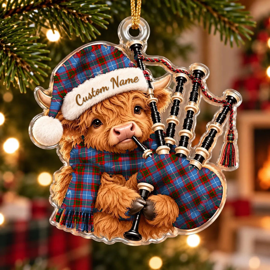 Acrylic Highland cow calf ornament playing the bagpipes, in a Pennycook (Edinburgh) tartan Santa hat, scarf and pipe bag, with a custom name on the hat