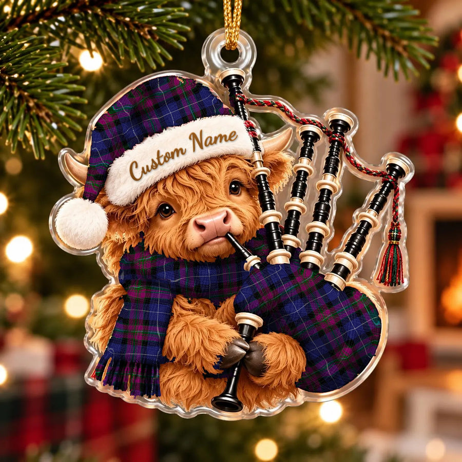 Acrylic Highland cow calf ornament playing the bagpipes, in a Pride of Scotland tartan Santa hat, scarf and pipe bag, with a custom name on the hat