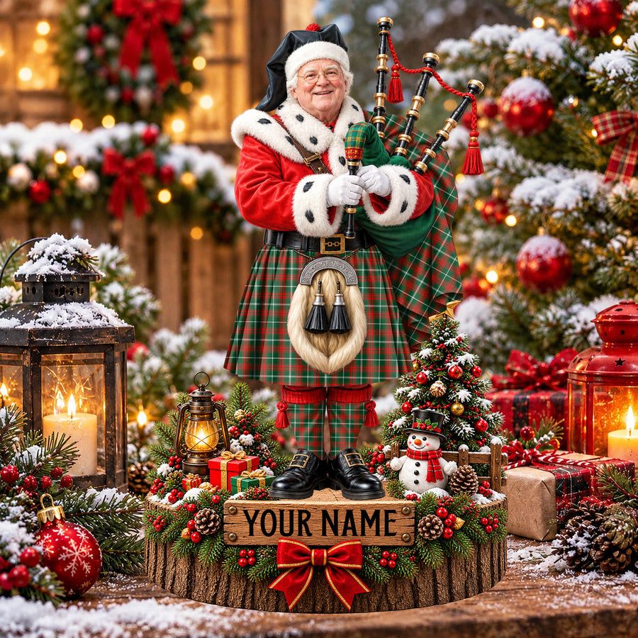 Personalized Christmas piper plaque in the Prince of Wales tartan, standing on a snowy log base with a name plaque