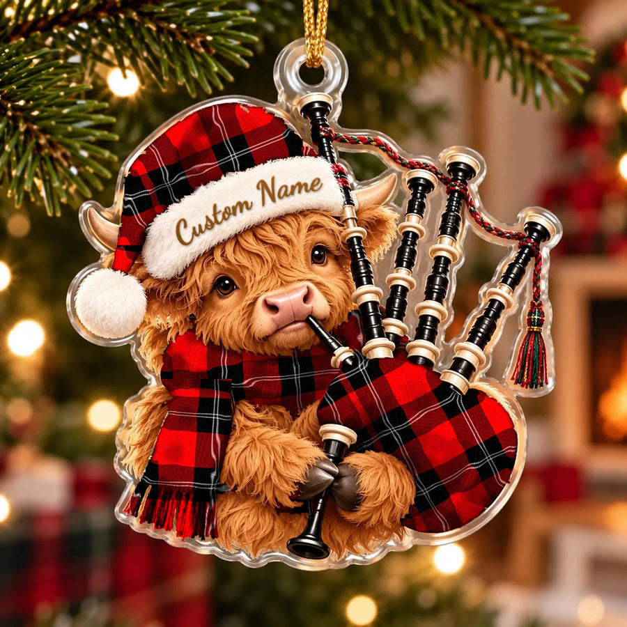 Acrylic Highland cow calf ornament playing the bagpipes, in a Ramsay Modern tartan Santa hat, scarf and pipe bag, with a custom name on the hat