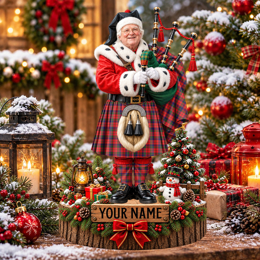 Personalized Christmas piper plaque in the Robertson Modern tartan, standing on a snowy log base with a name plaque