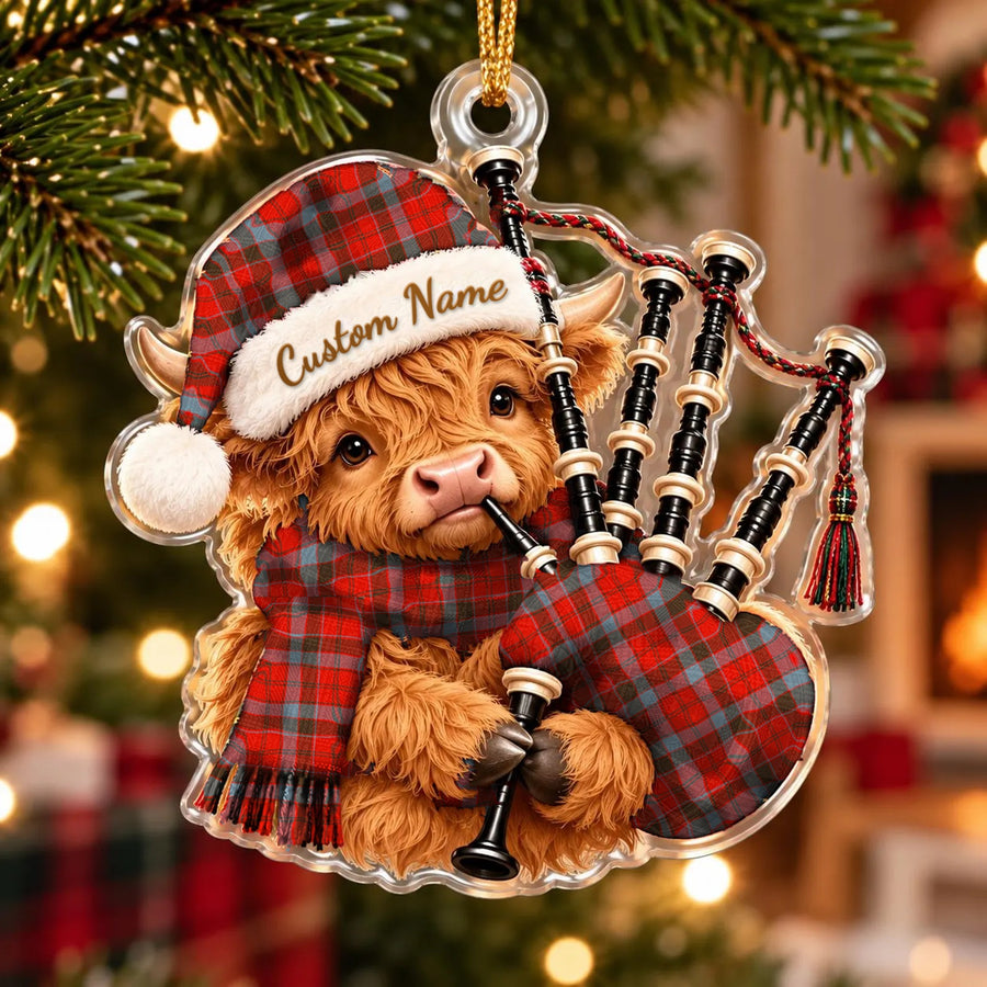 Acrylic Highland cow calf ornament playing the bagpipes, in a Robertson Weathered tartan Santa hat, scarf and pipe bag, with a custom name on the hat