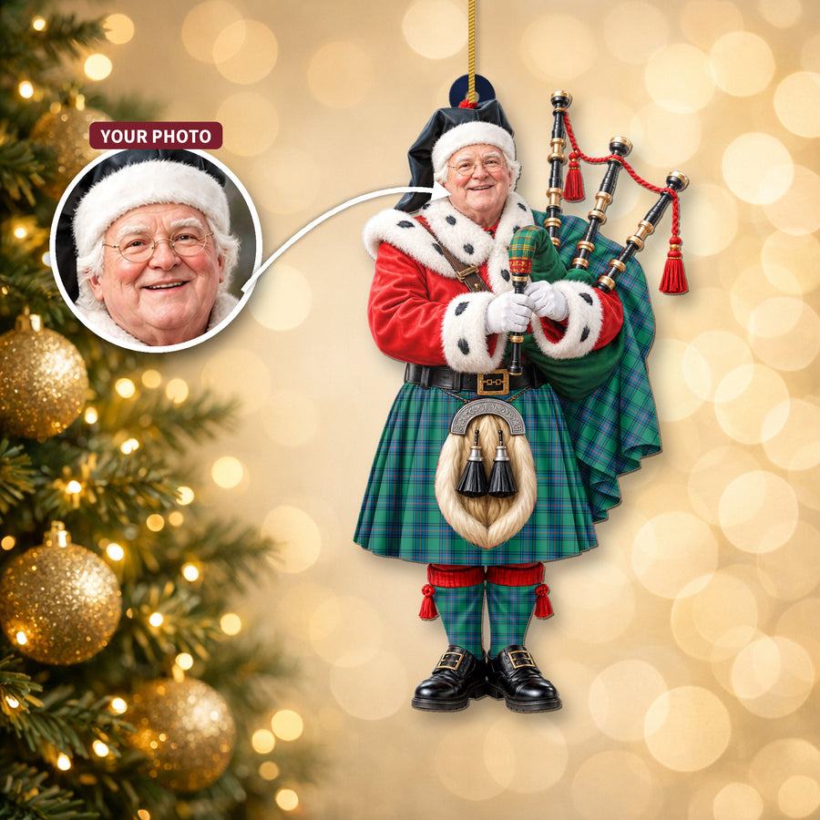 Christmas piper ornament in the Shaw Ancient tartan hanging on a Christmas tree, with the customer photo used for the face