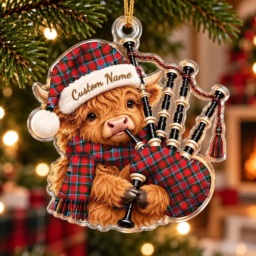 Acrylic Highland cow calf ornament playing the bagpipes, in a Sinclair Modern tartan Santa hat, scarf and pipe bag, with a custom name on the hat