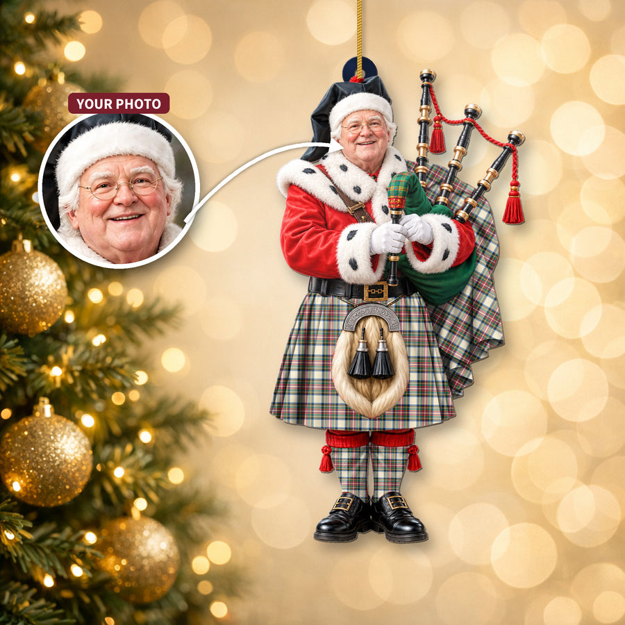 Christmas piper ornament in the Stewart Dress Ancient tartan hanging on a Christmas tree, with the customer photo used for the face