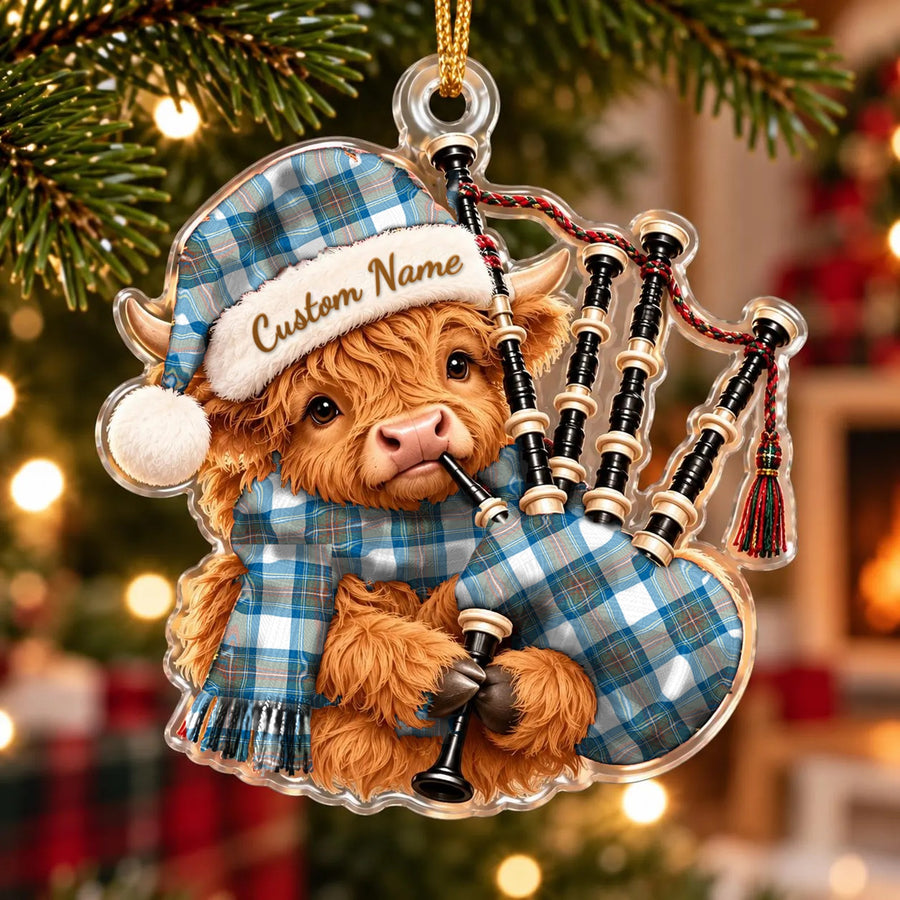 Acrylic Highland cow calf ornament playing the bagpipes, in a Stewart Muted Blue tartan Santa hat, scarf and pipe bag, with a custom name on the hat