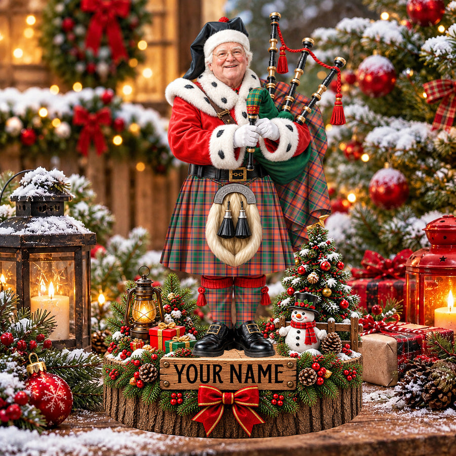 Personalized Christmas piper plaque in the Stewart of Appin Ancient tartan, standing on a snowy log base with a name plaque