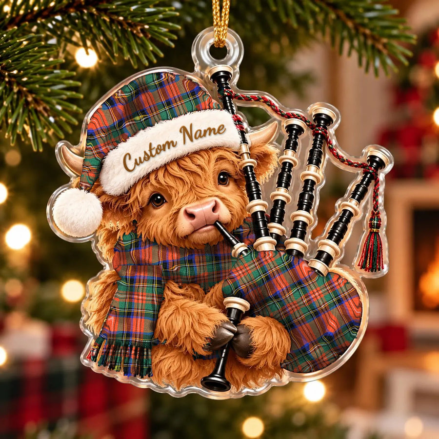 Acrylic Highland cow calf ornament playing the bagpipes, in a Stewart Royal Ancient tartan Santa hat, scarf and pipe bag, with a custom name on the hat