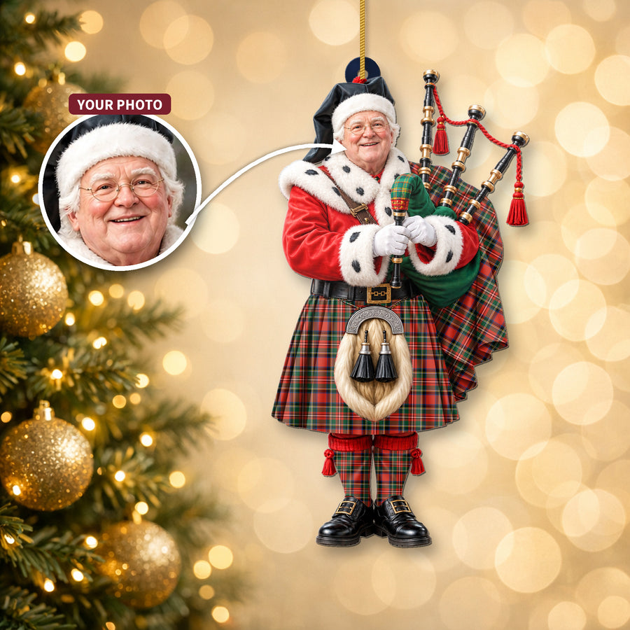 Christmas piper ornament in the Stewart Royal Modern tartan hanging on a Christmas tree, with the customer photo used for the face