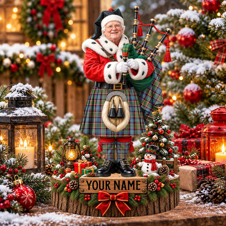 Personalized Christmas piper plaque in the Stirling (of Keir) tartan, standing on a snowy log base with a name plaque