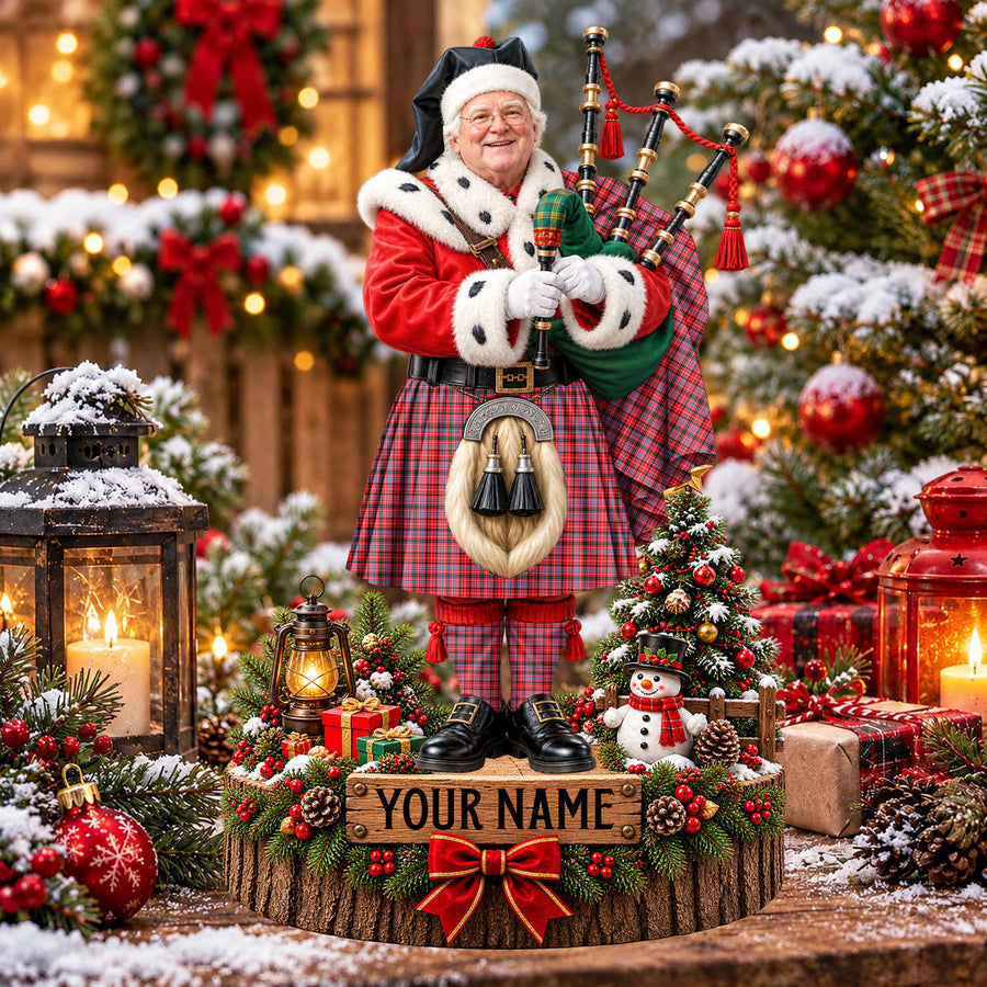 Personalized Christmas piper plaque in the Straiton Aderbeen tartan, standing on a snowy log base with a name plaque