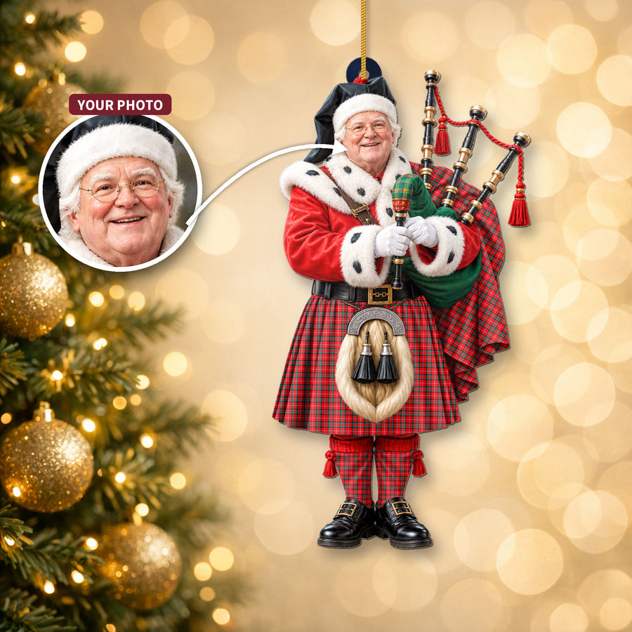 Christmas piper ornament in the Stuart of Bute tartan hanging on a Christmas tree, with the customer photo used for the face