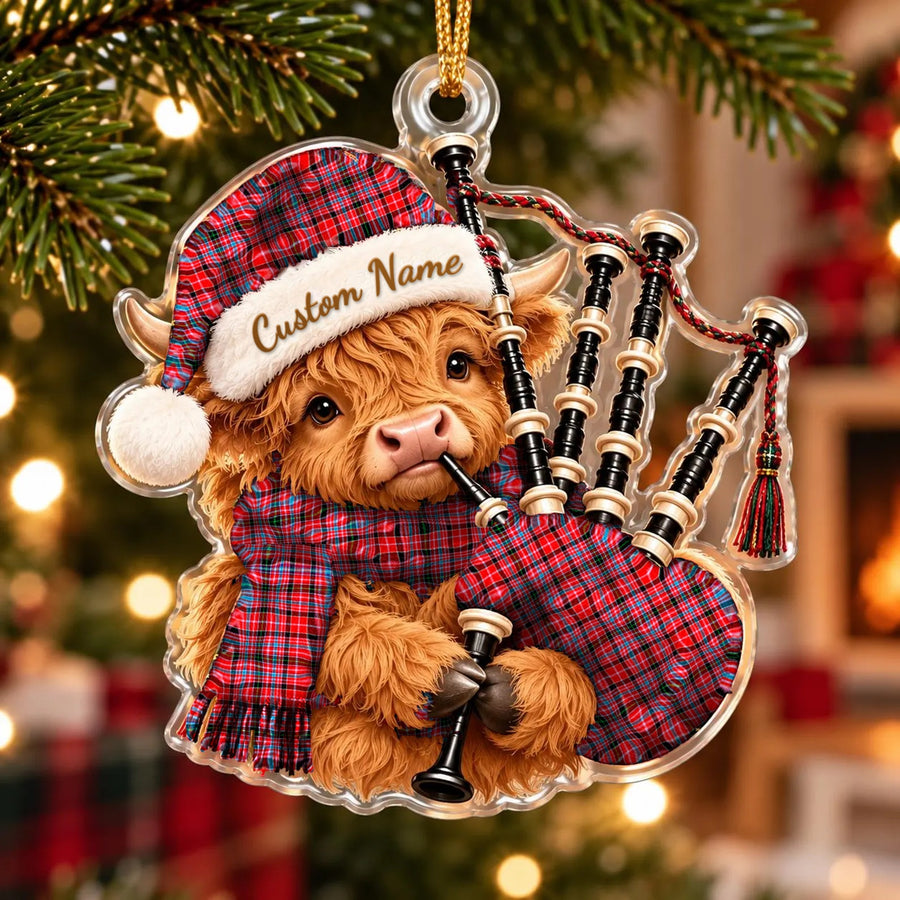 Acrylic Highland cow calf ornament playing the bagpipes, in a Udny tartan Santa hat, scarf and pipe bag, with a custom name on the hat